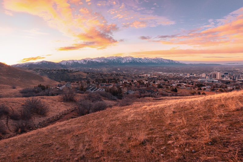 Salt Lake City beyond golden hills and against the mountains